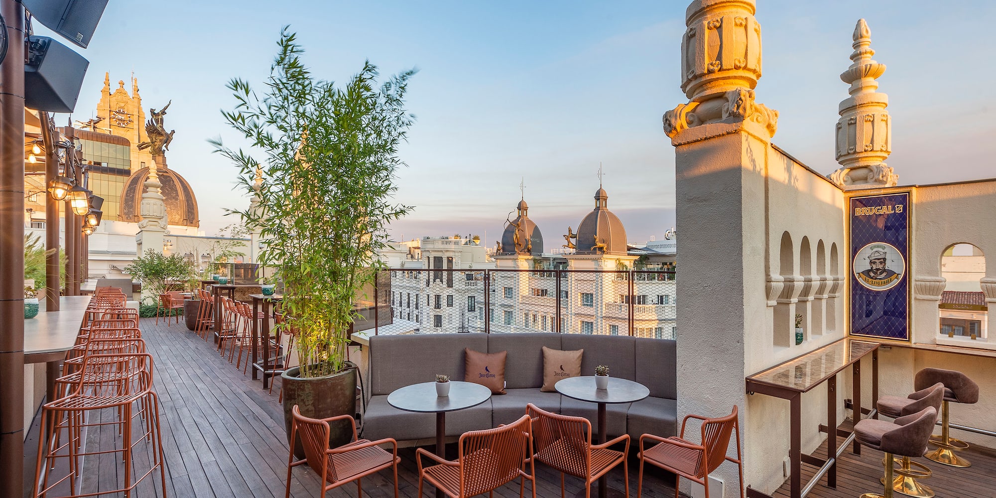 a rooftop patio with tables and chairs