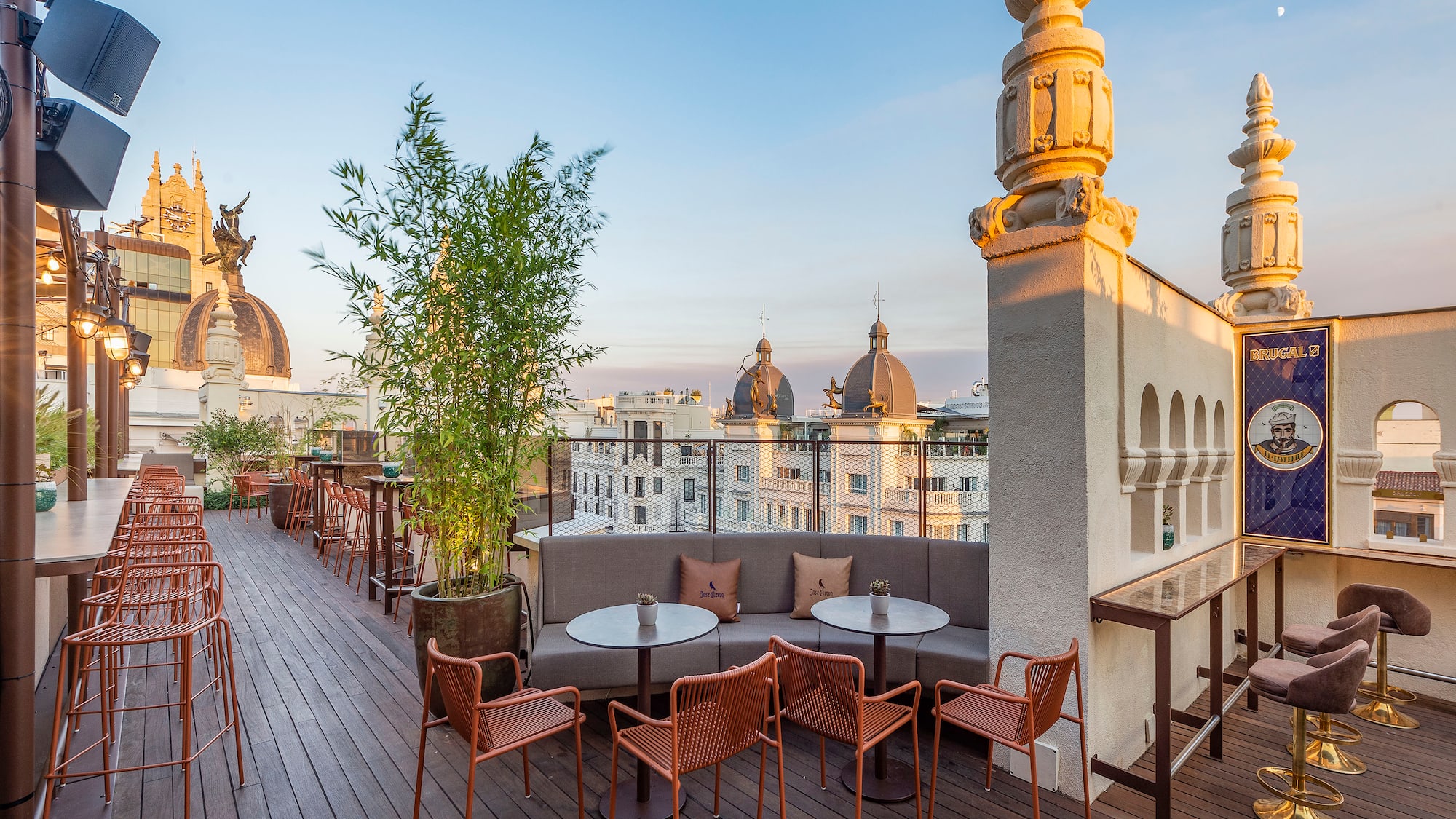 a rooftop patio with tables and chairs