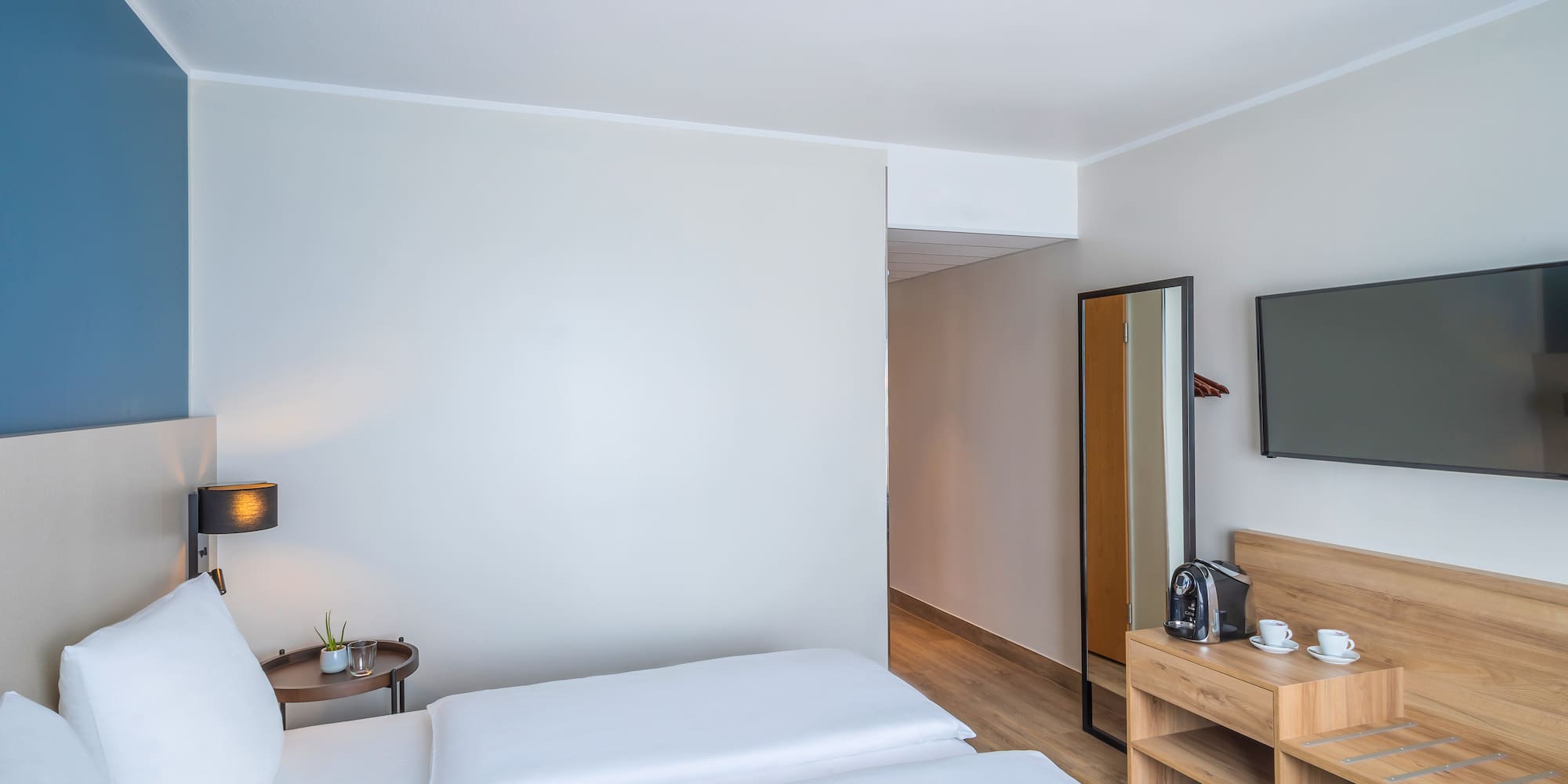 a room with a bed and a mirror