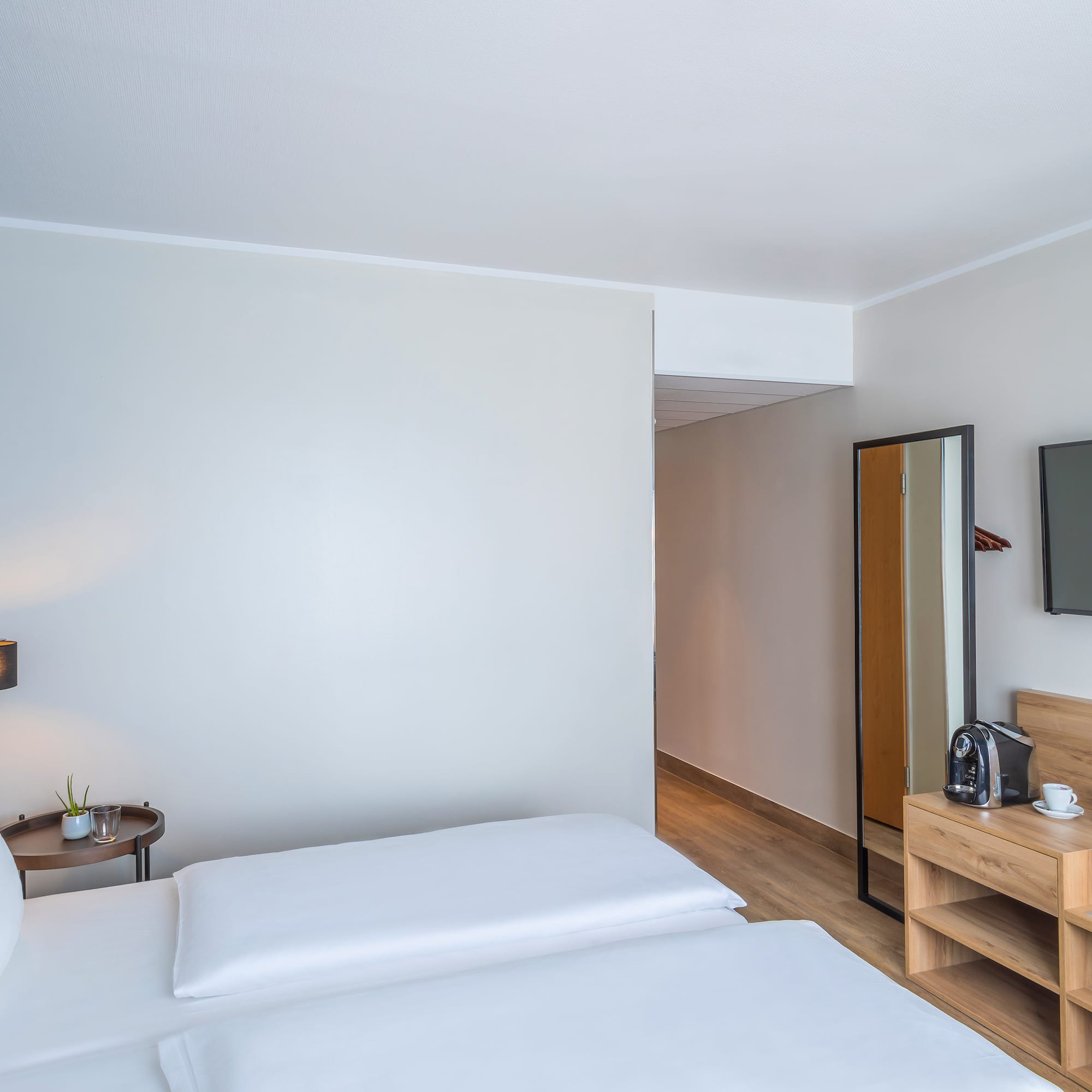 a room with a bed and a mirror