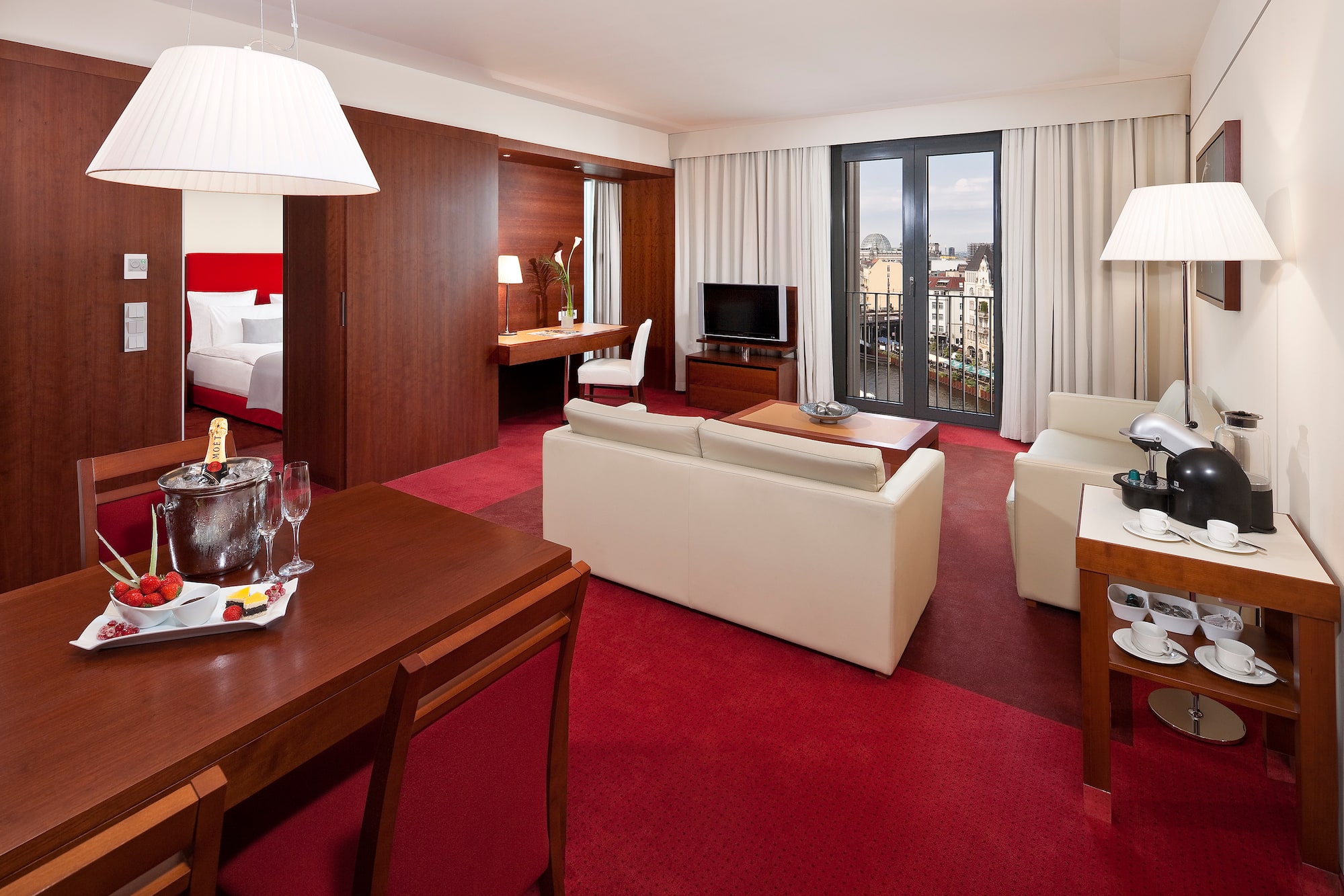 a room with red carpet and white furniture