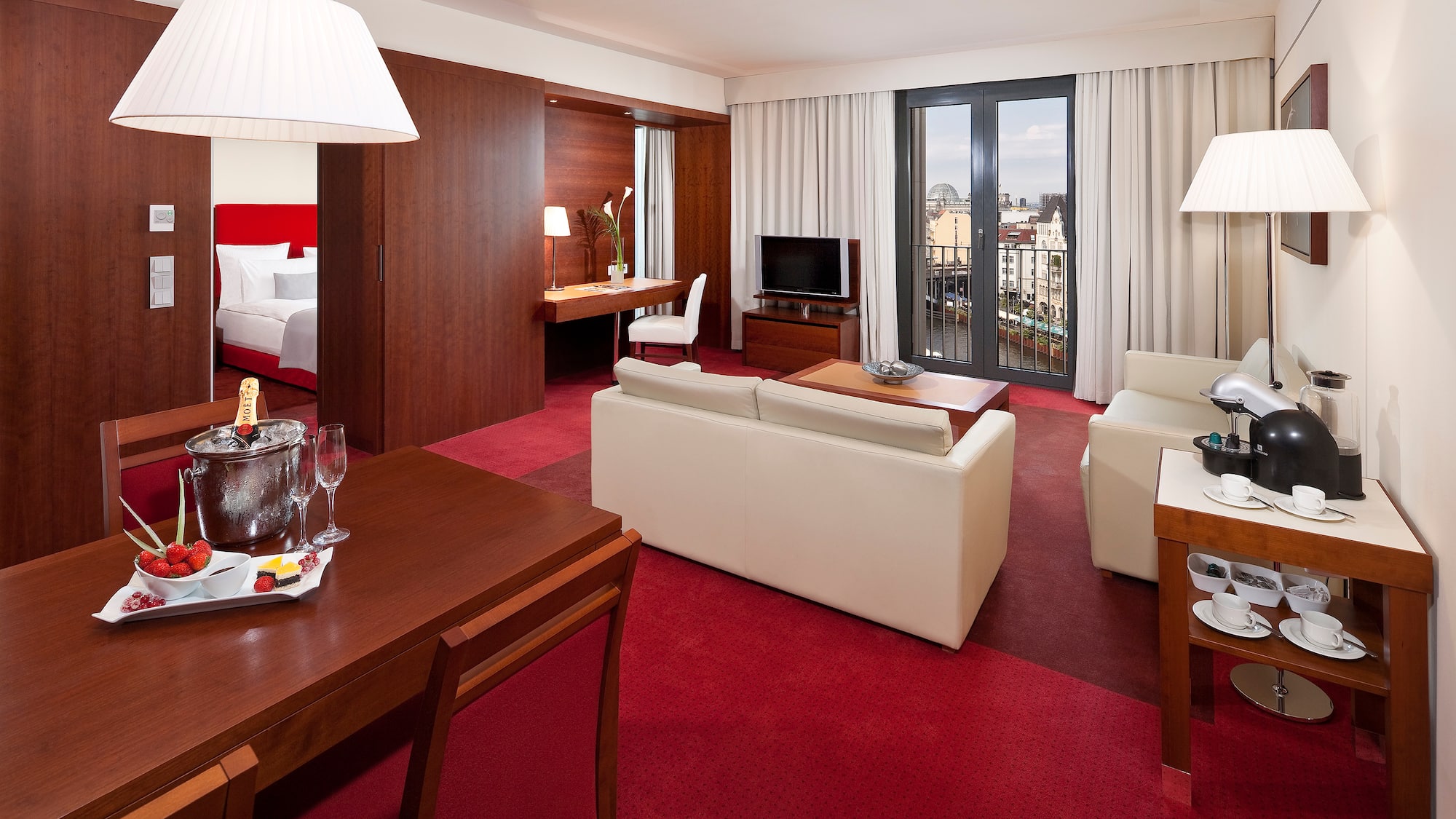 a room with red carpet and white furniture