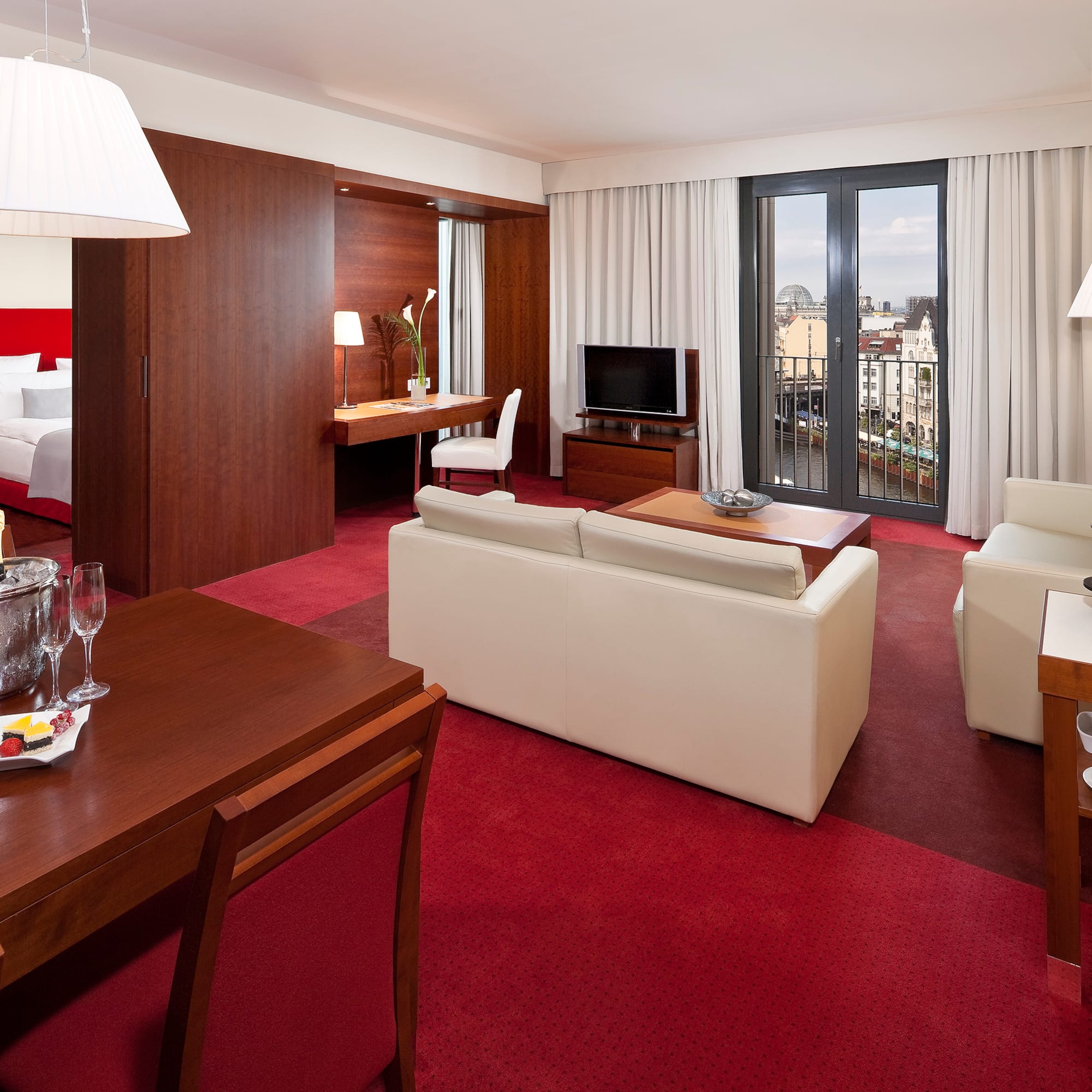 a room with red carpet and white furniture