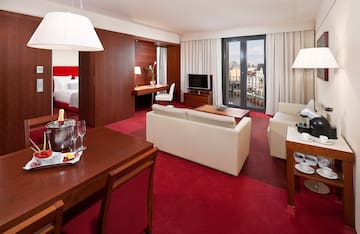 a room with red carpet and white furniture