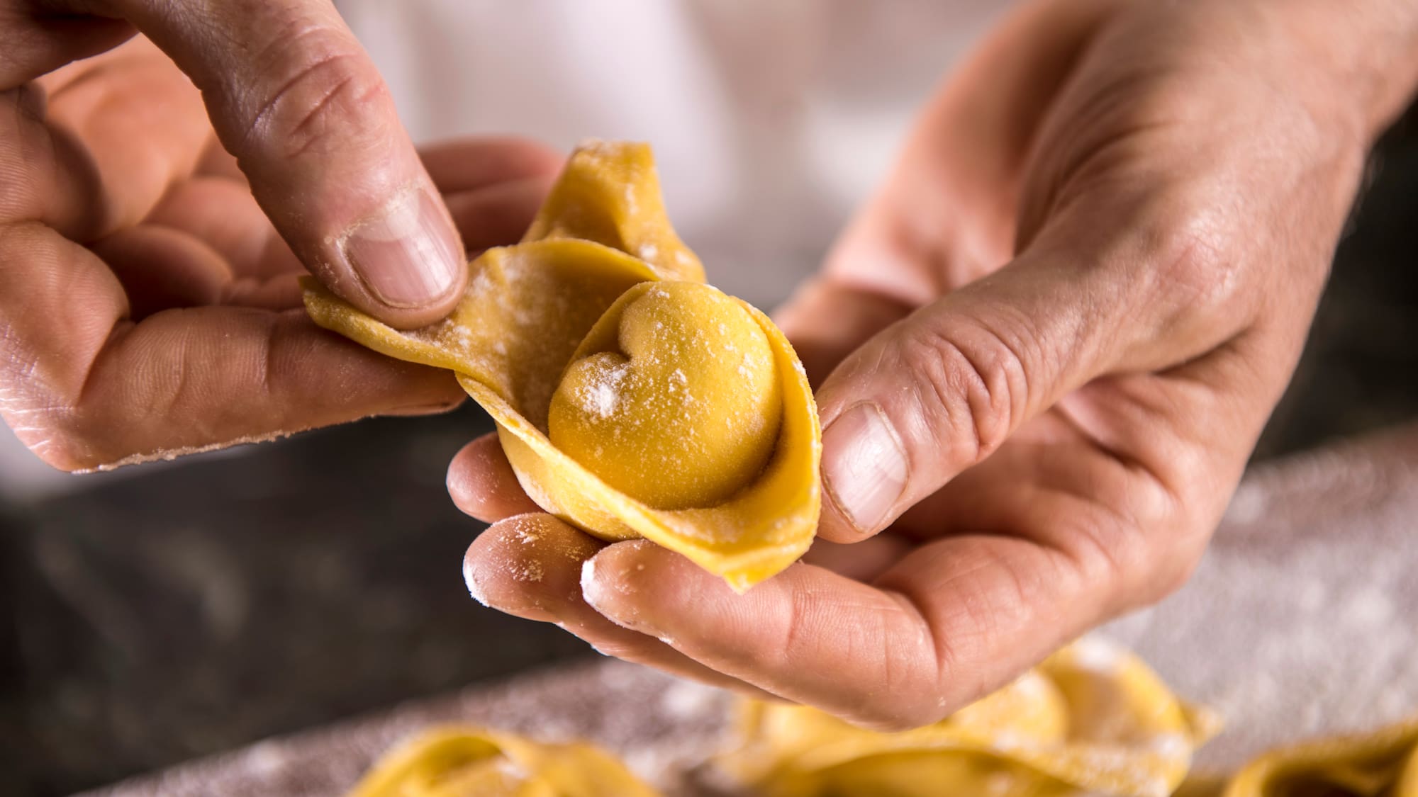 a person holding a tortellini