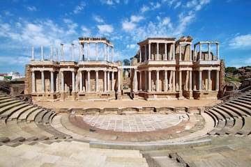 a stone building with columns and a circular stage