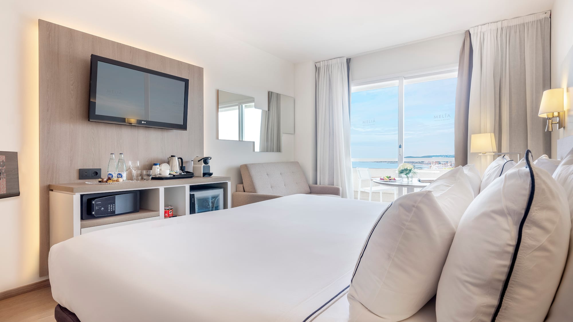 a room with a bed and a television