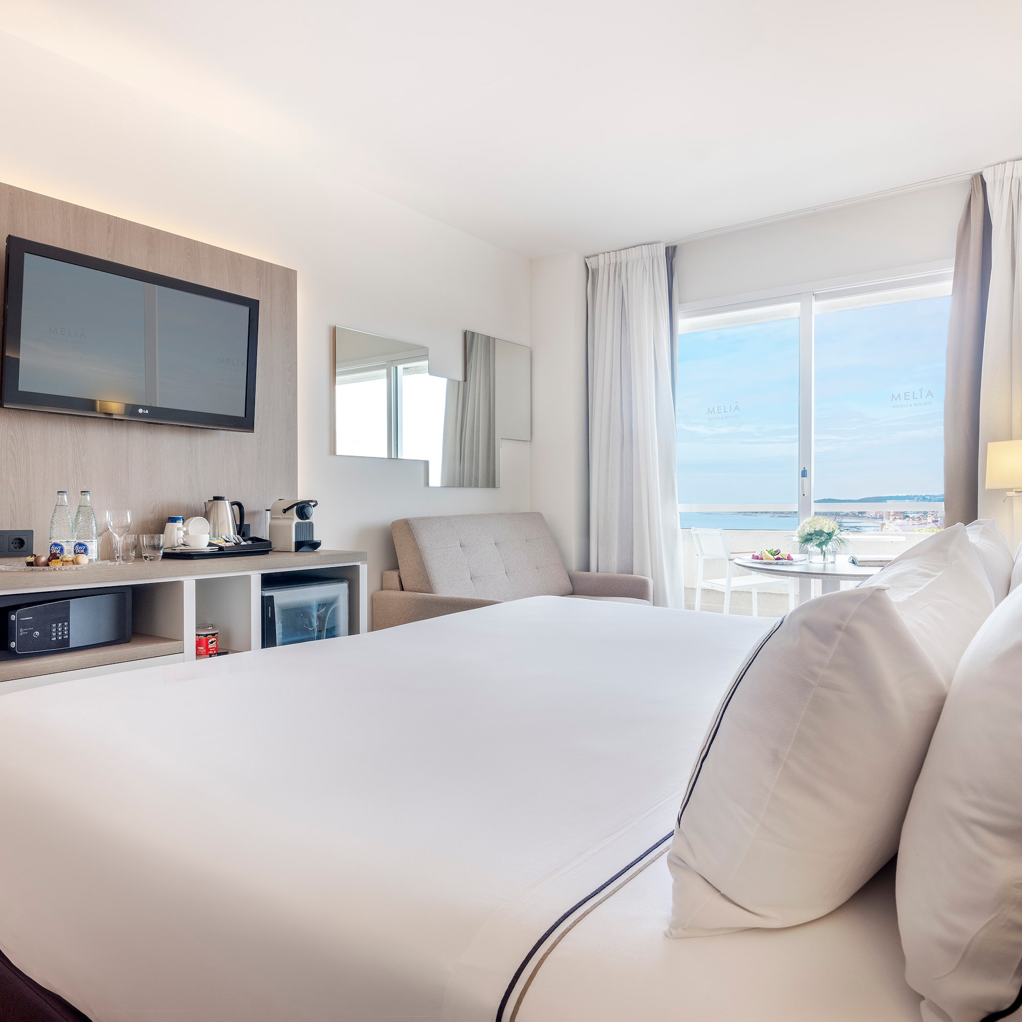 a room with a bed and a television