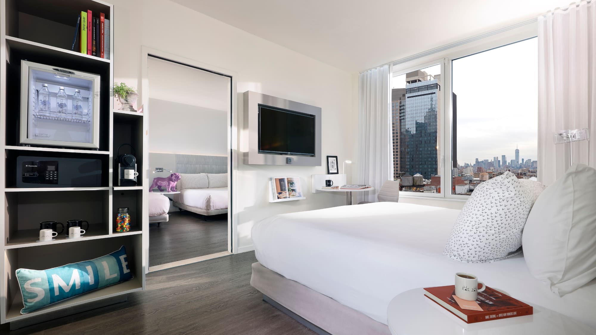 a bedroom with a large bed and a large mirror