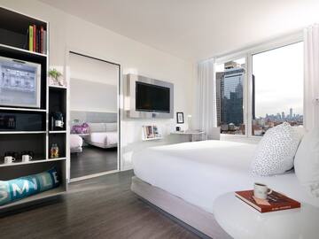 a bedroom with a large bed and a large mirror
