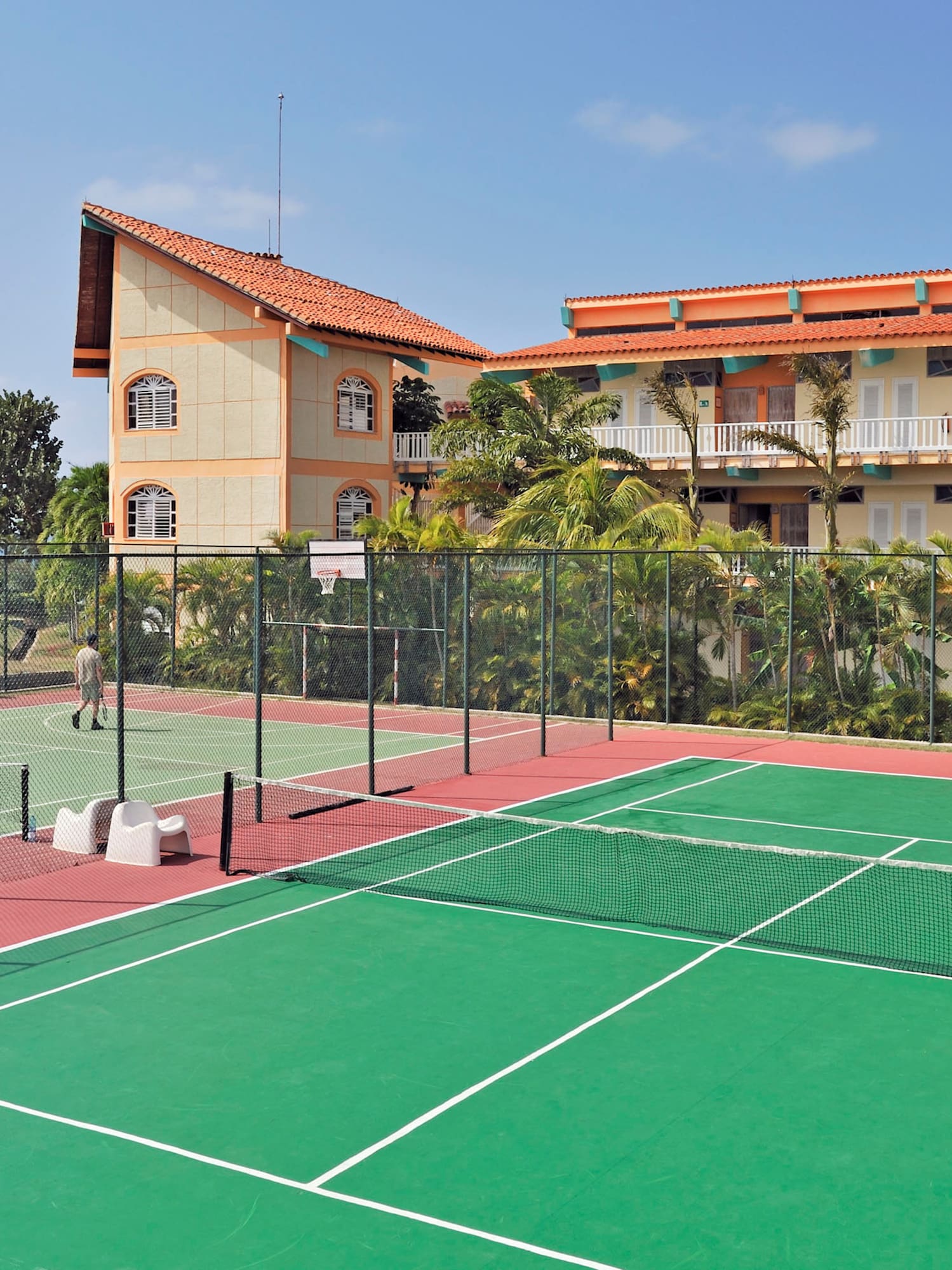 a tennis court with a building in the background