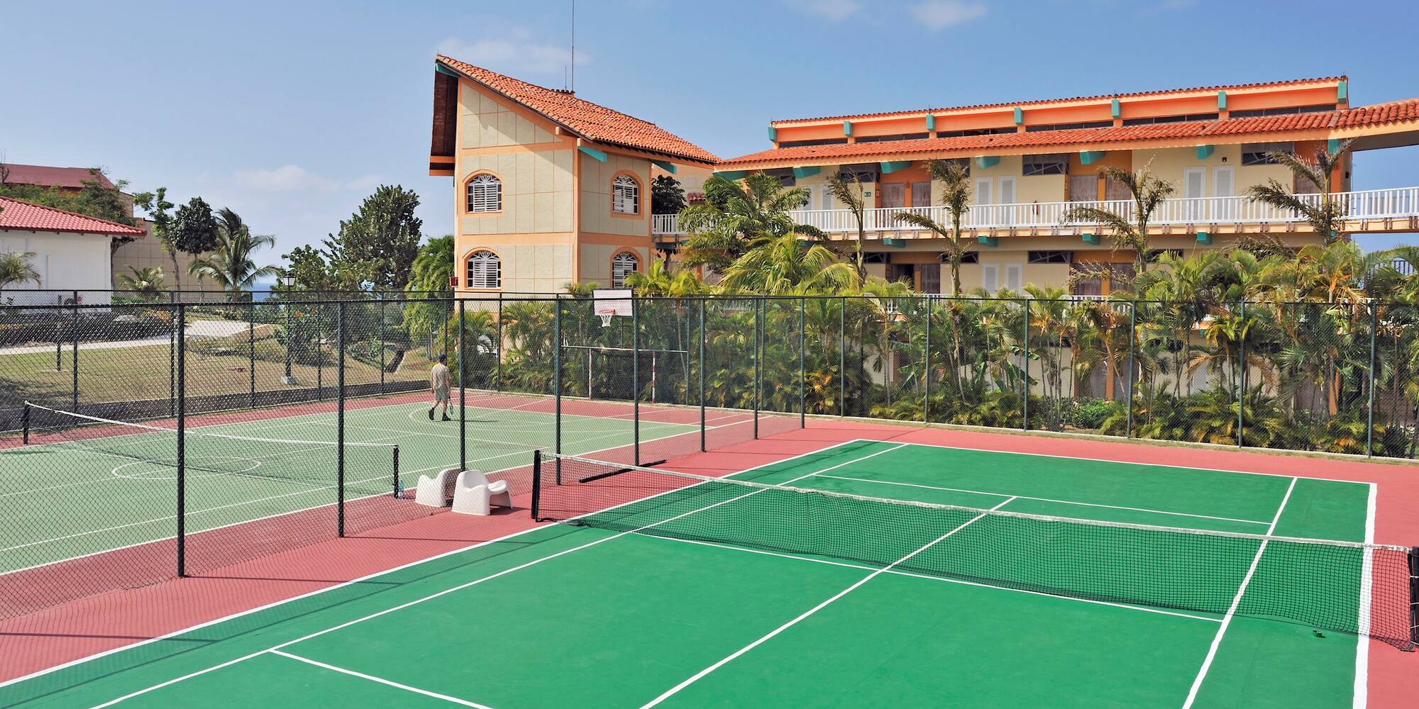 a tennis court with a building in the background