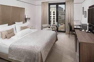 a bedroom with a bed and a table and chairs