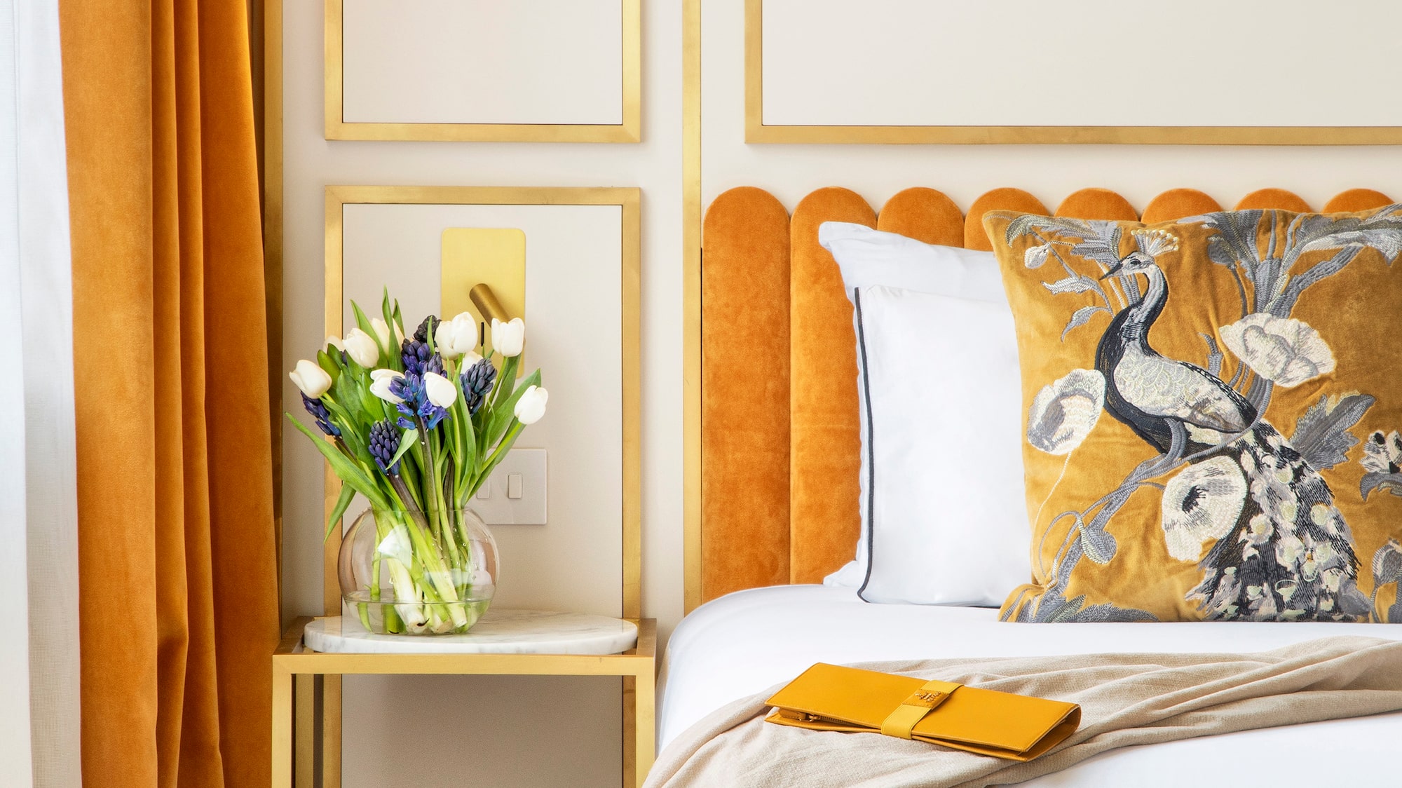 a bed with a vase of flowers on it