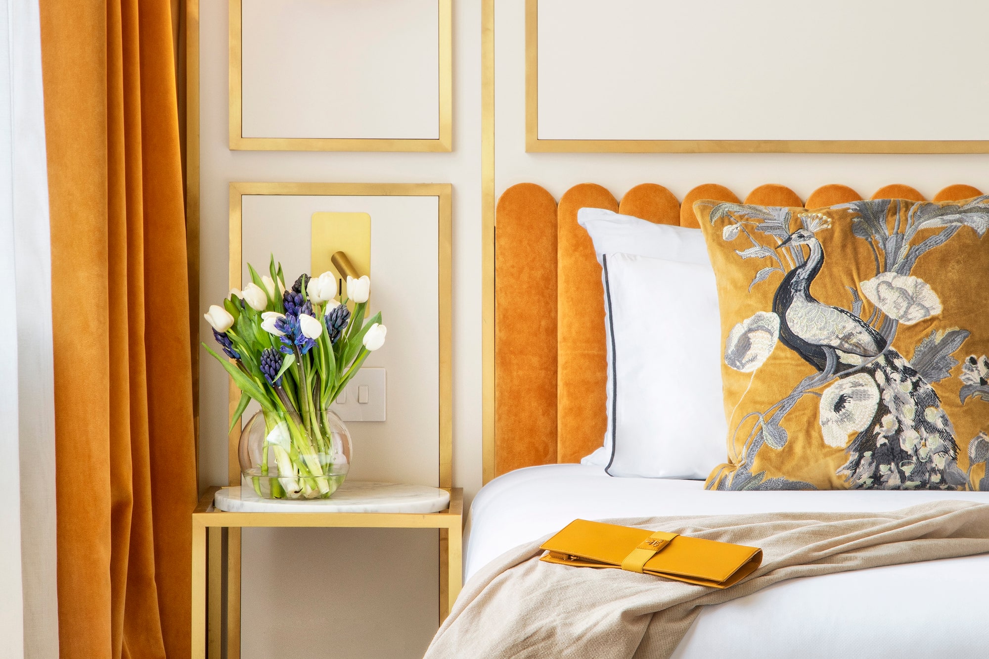 a bed with a vase of flowers on it