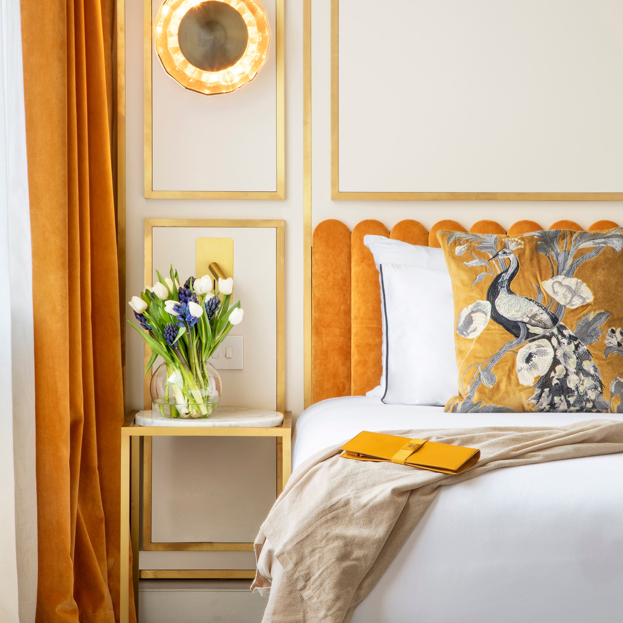 a bed with a vase of flowers on it