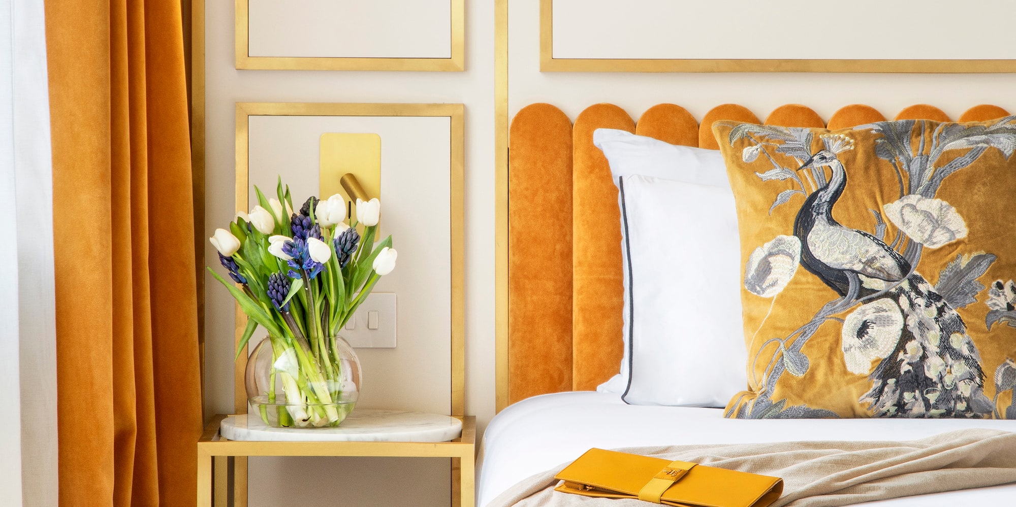 a bed with a vase of flowers on it