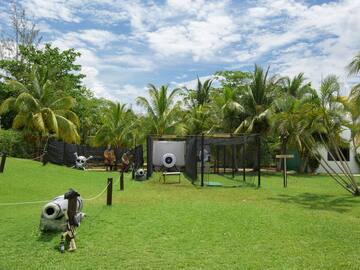 a playground with a gun and a gun in the middle of a field