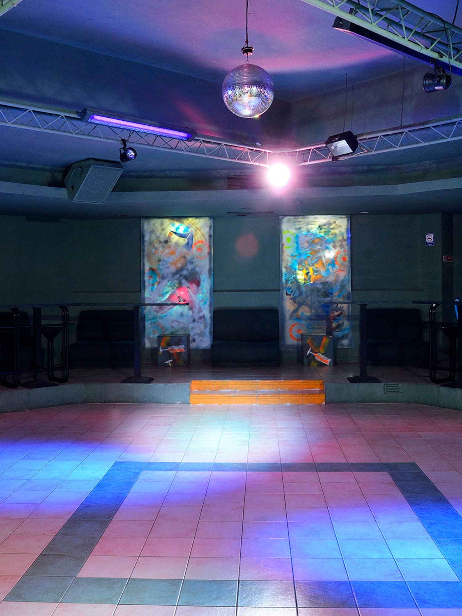 a room with a mirror ball and a mirror on the ceiling