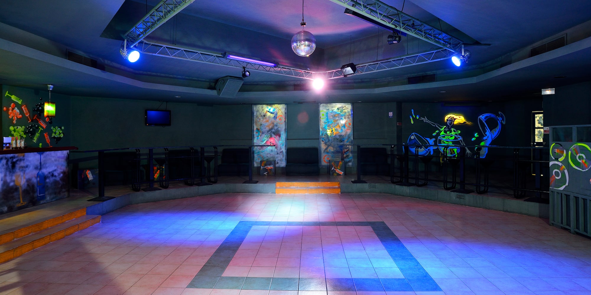 a room with a mirror ball and a mirror on the ceiling