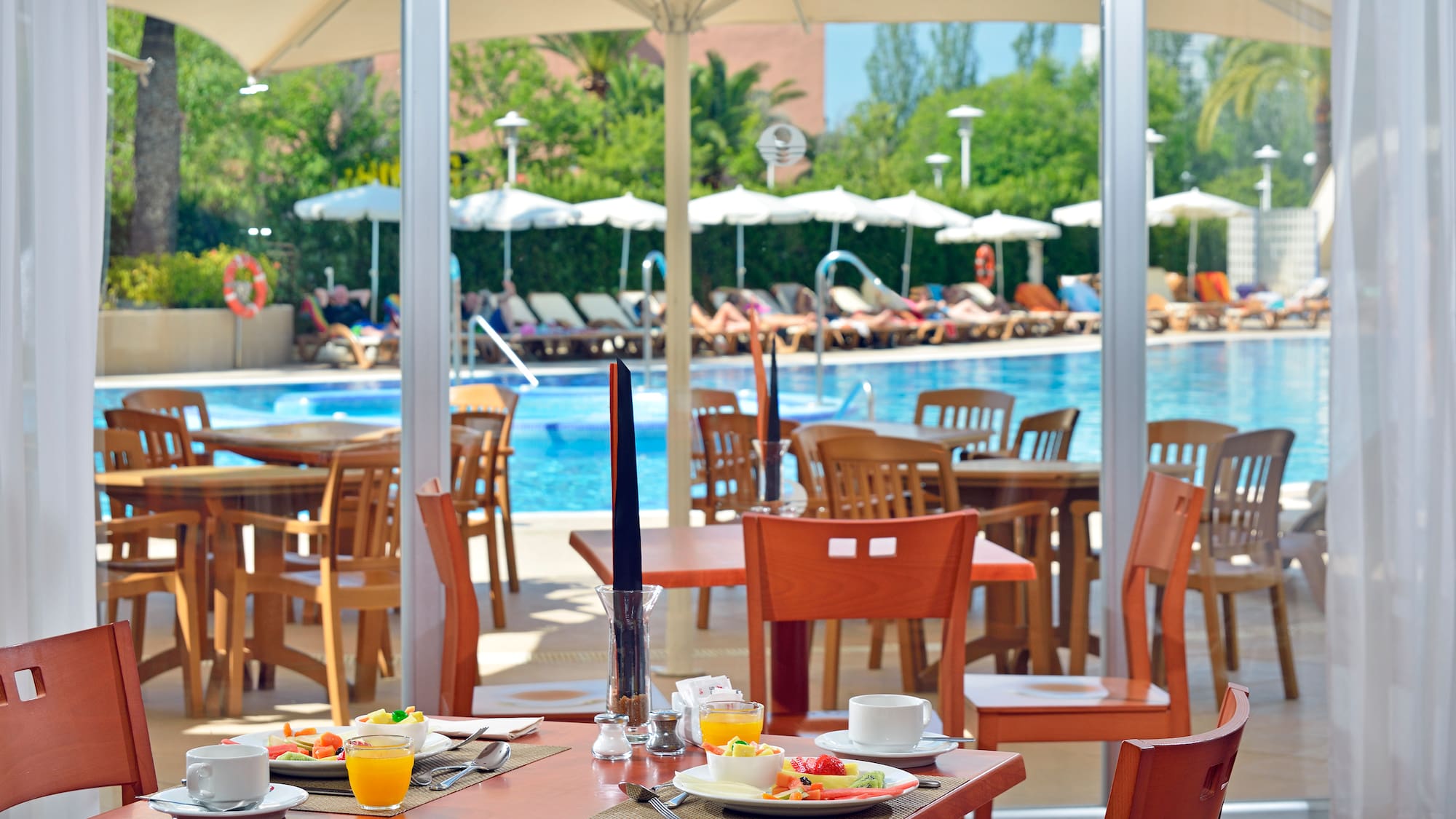 a table with food on it by a pool