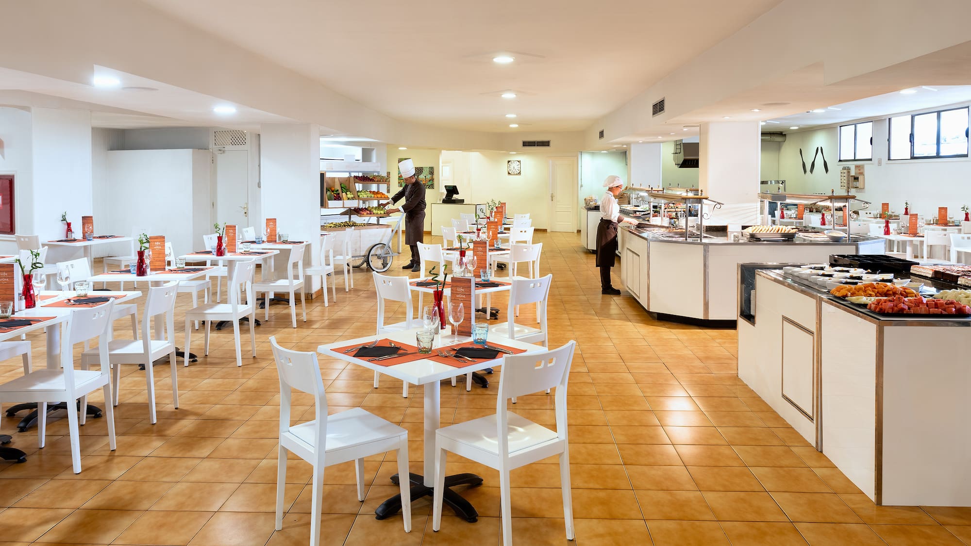 a restaurant with white tables and chairs