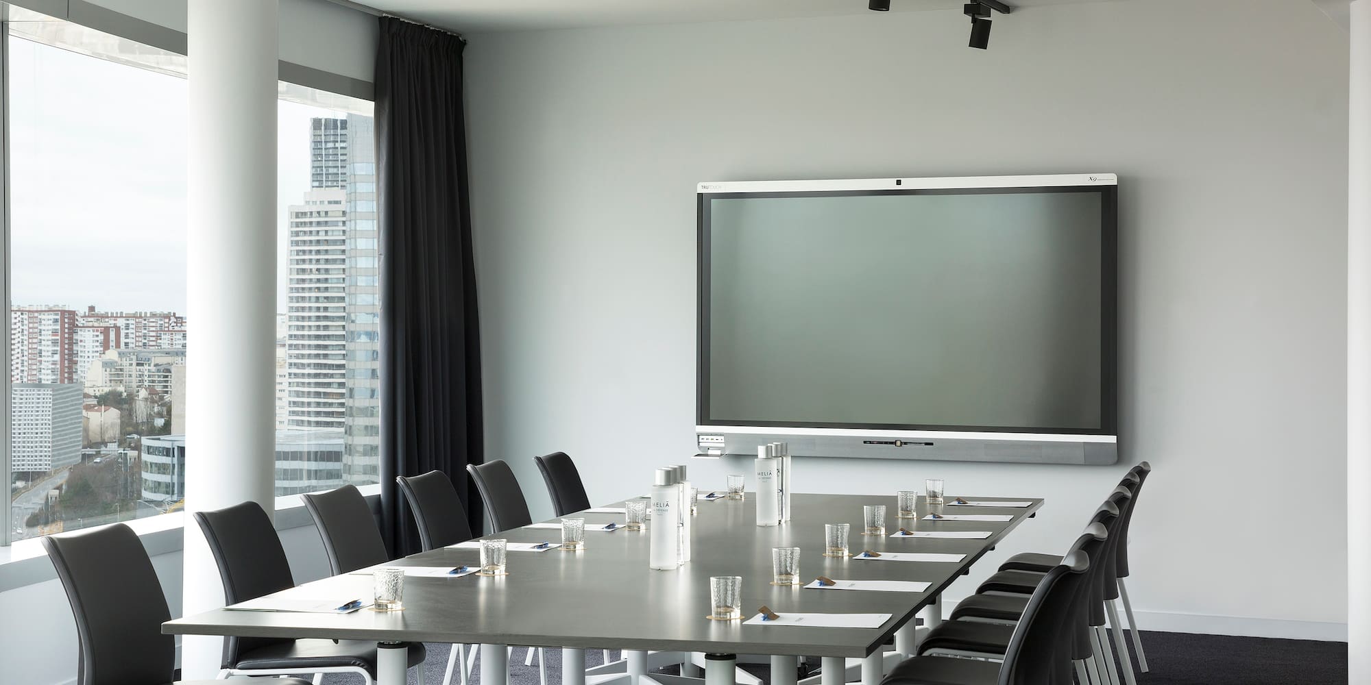 a conference room with a large screen