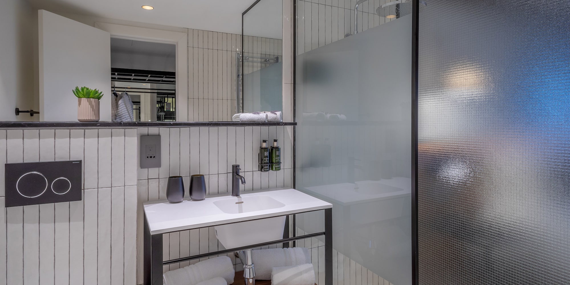 a bathroom with a glass shower and sink