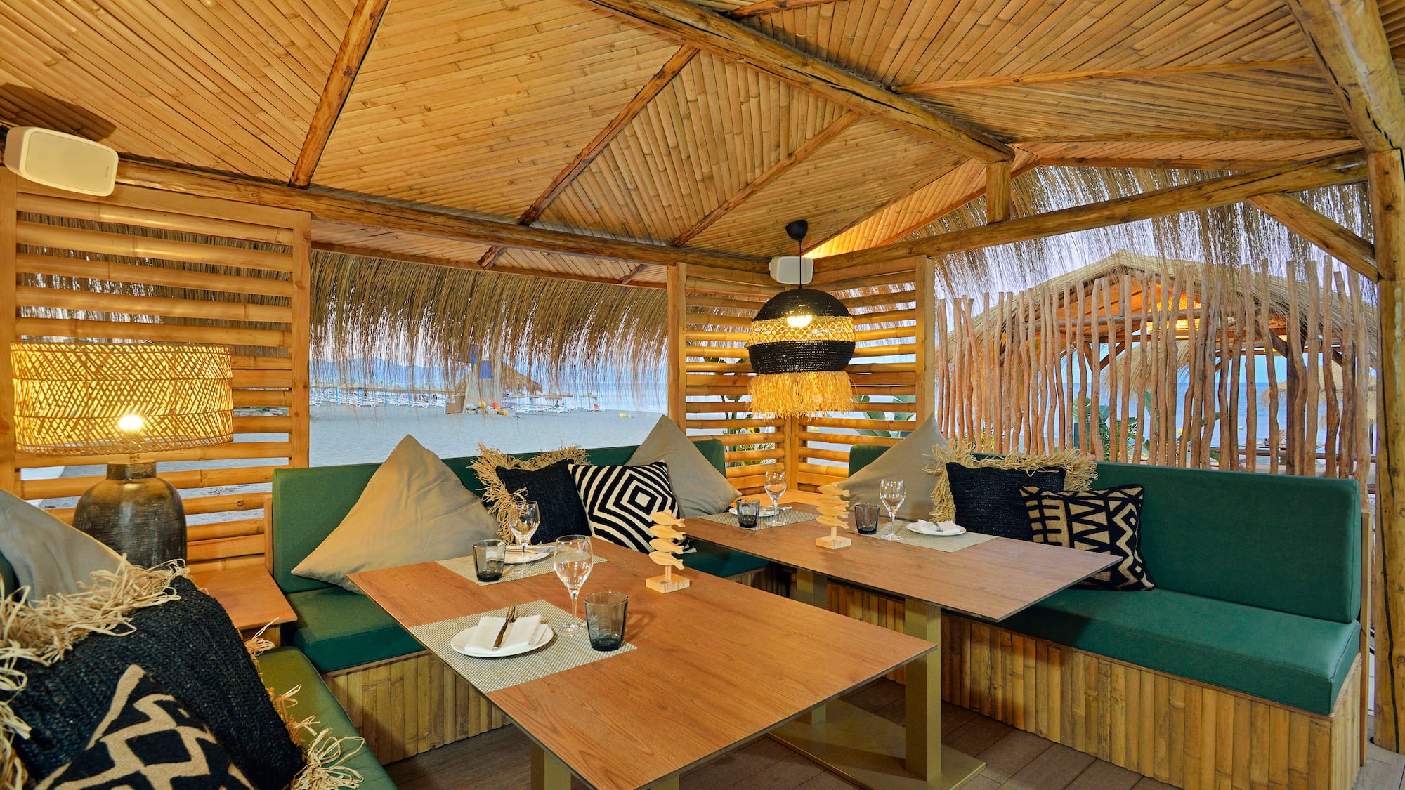 a table and chairs inside a hut