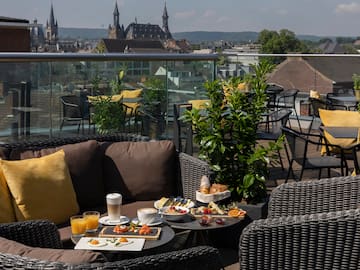 a table with food on it and chairs on a rooftop