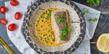 a fish and peas in a bowl