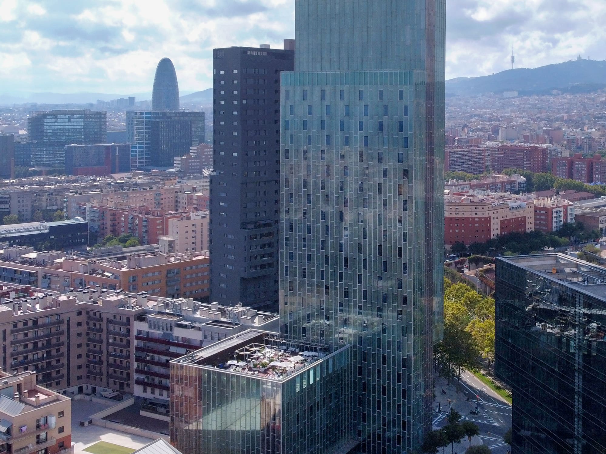 a tall glass building in a city