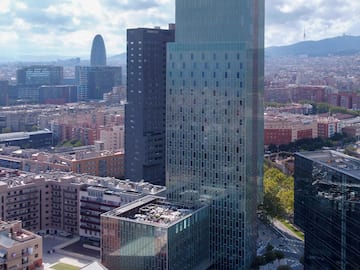 a tall glass building in a city
