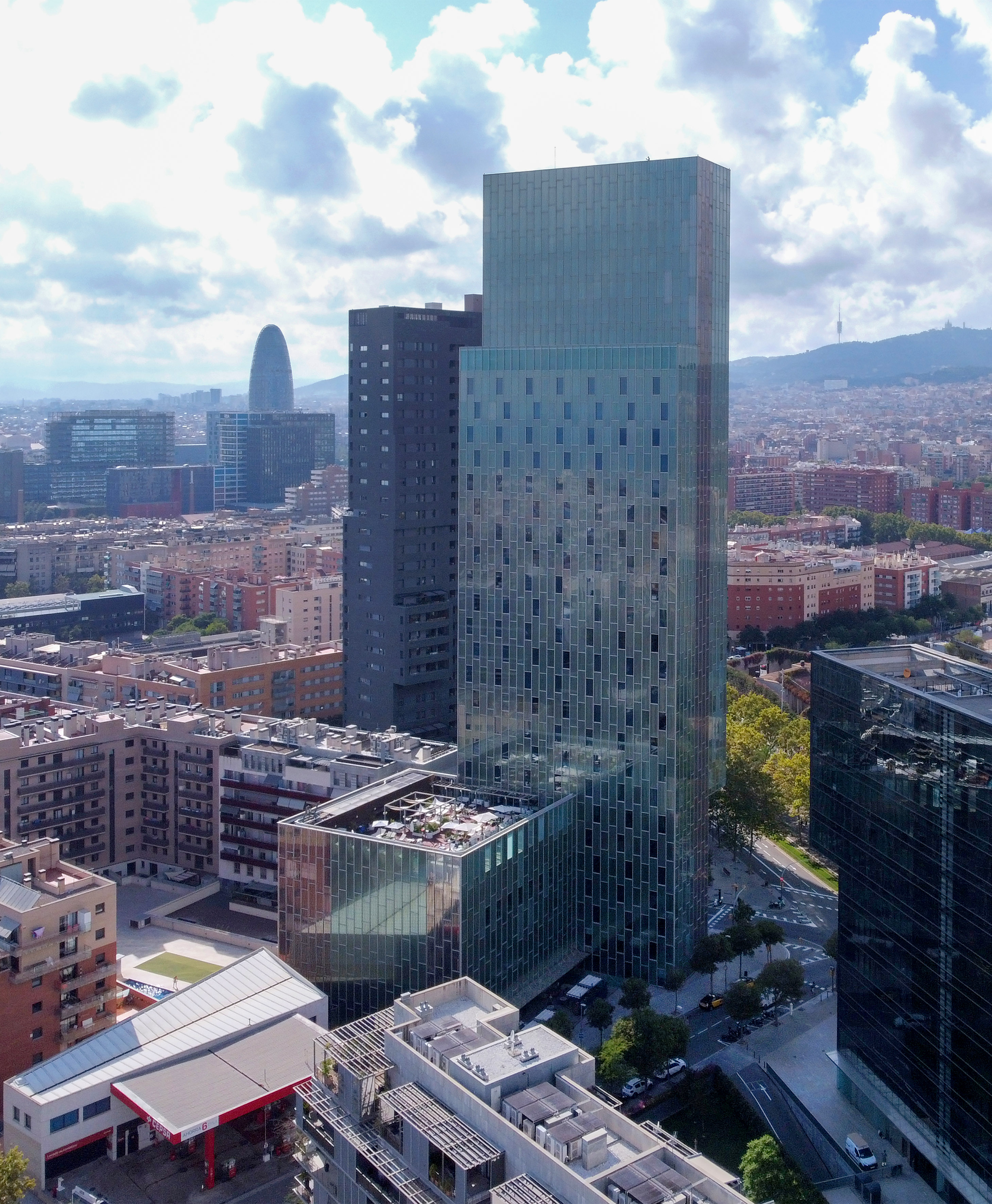 a tall glass building in a city