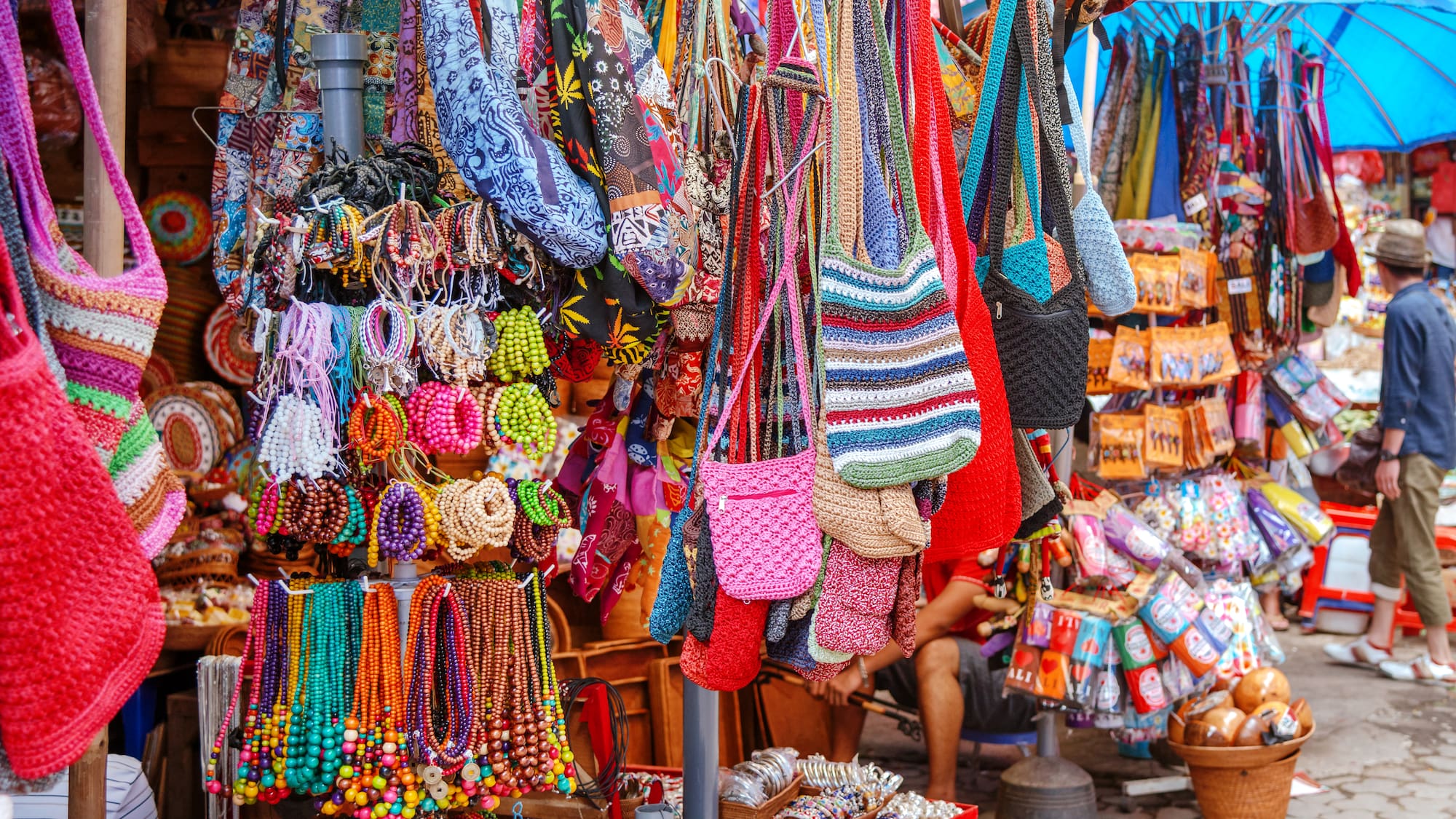 a display of colorful bags and necklaces