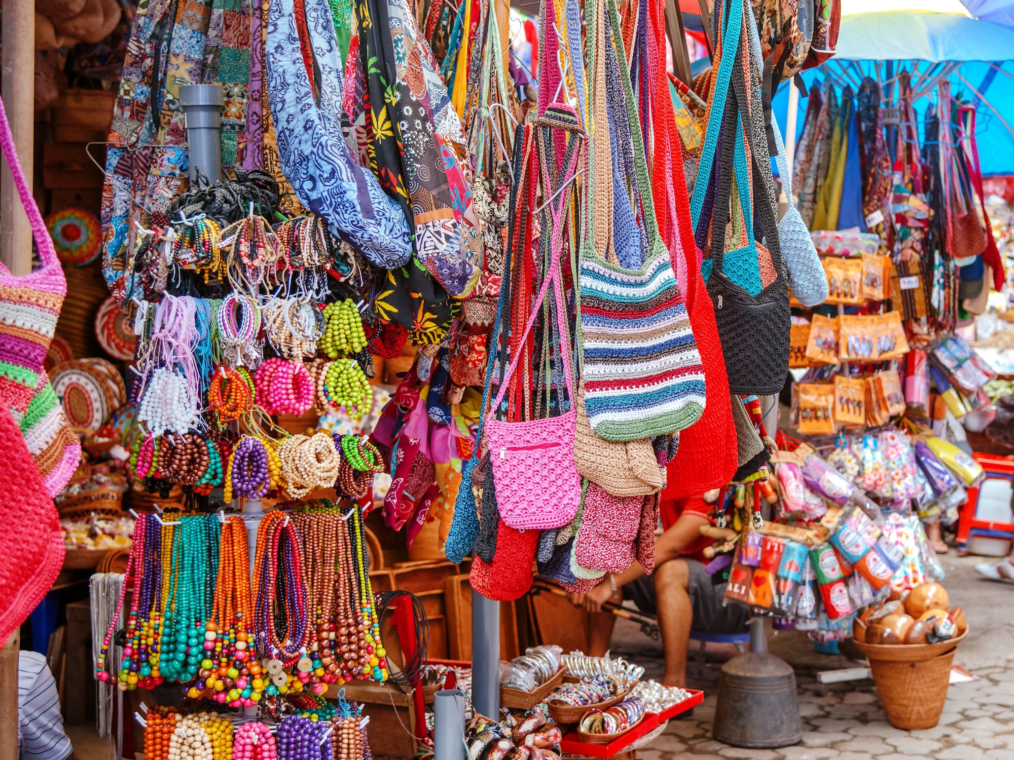 a display of colorful bags and necklaces