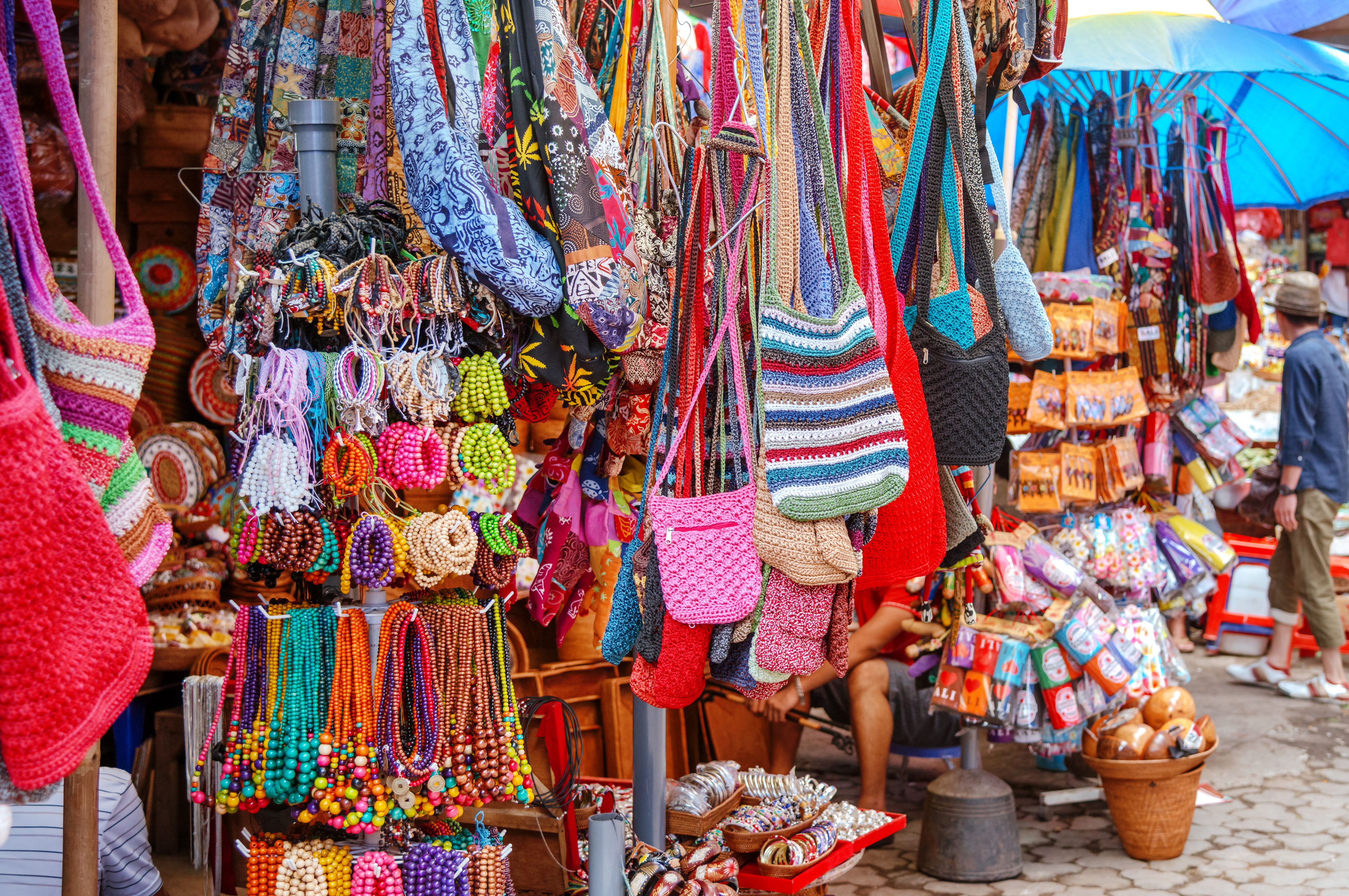 a display of colorful bags and necklaces