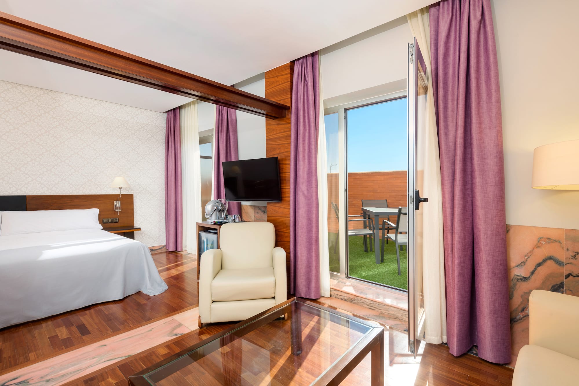 a room with a bed and a glass table