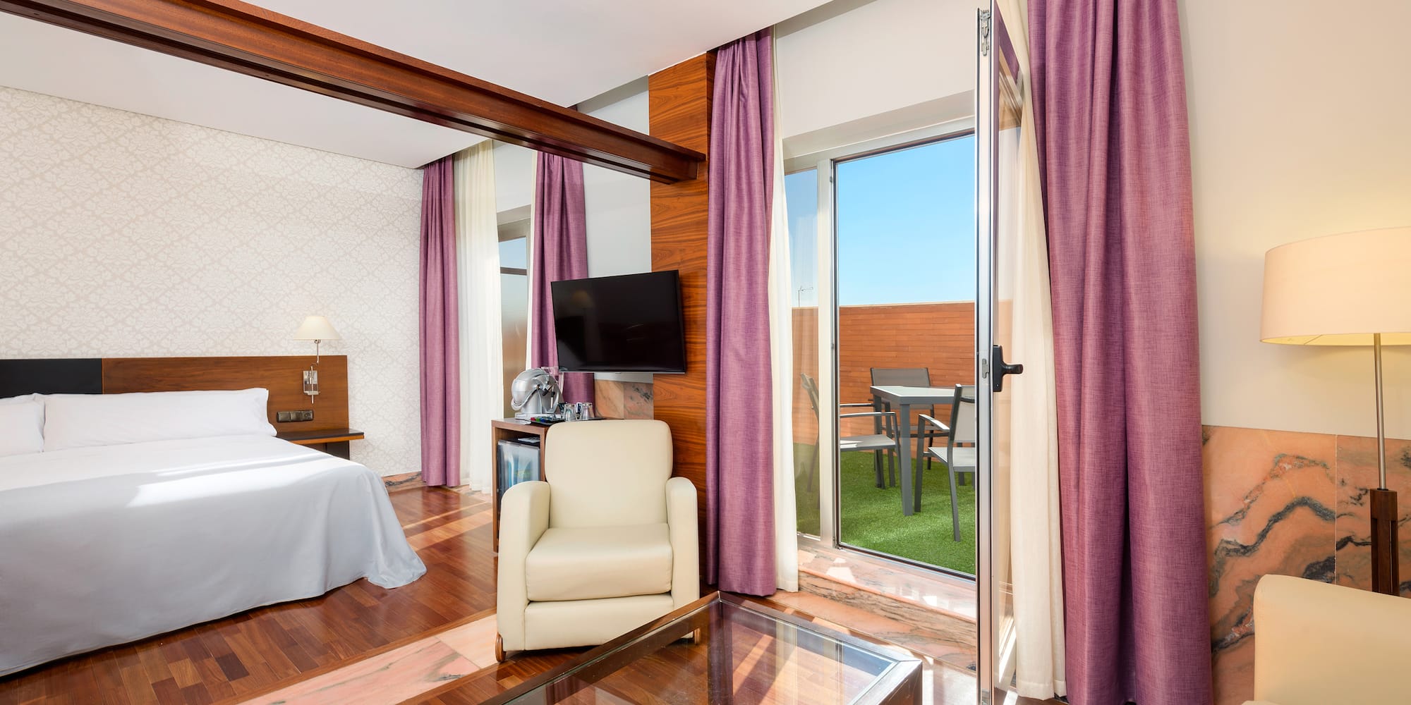 a room with a bed and a glass table