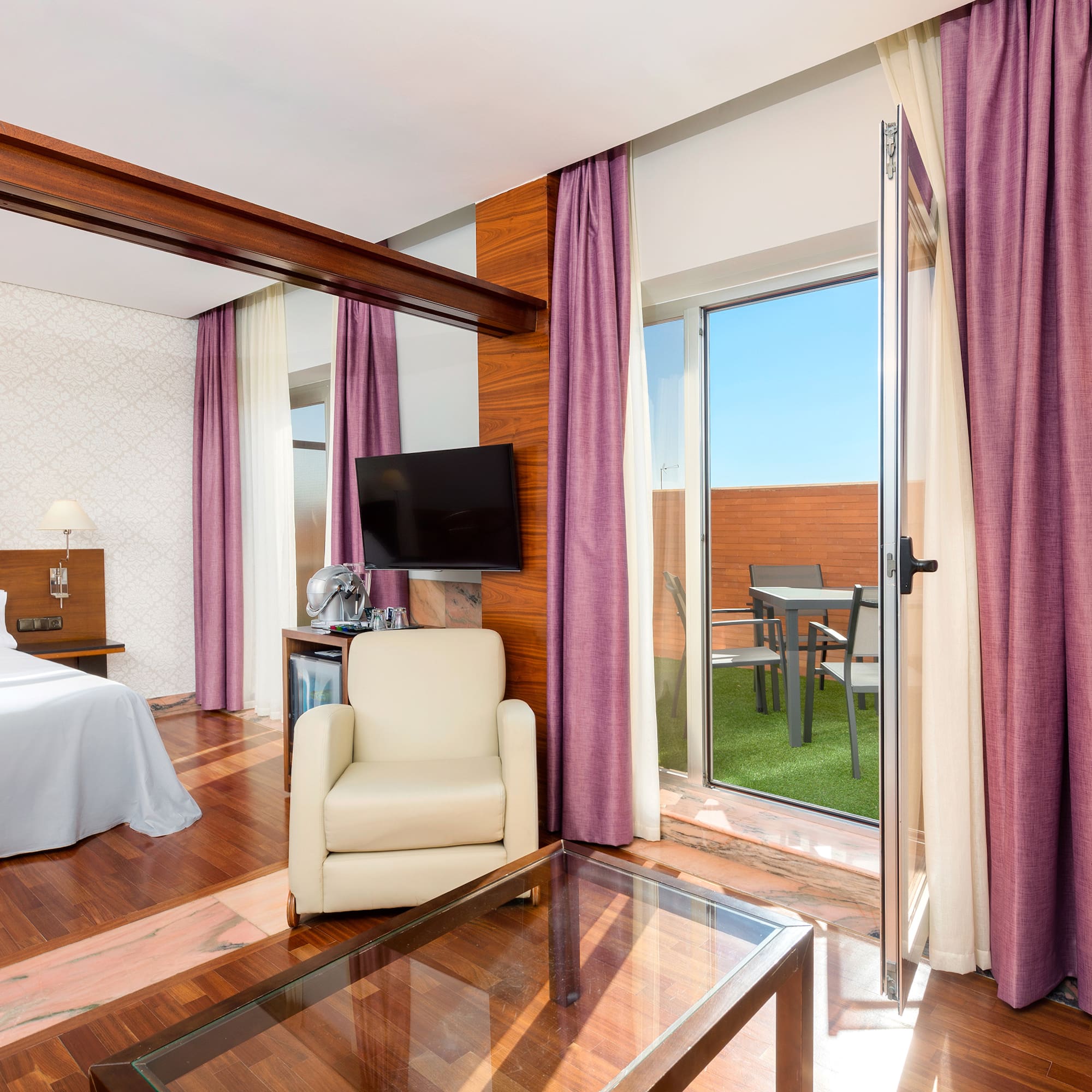 a room with a bed and a glass table