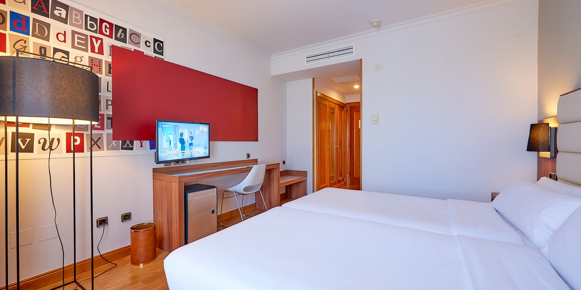 a room with a bed and a desk