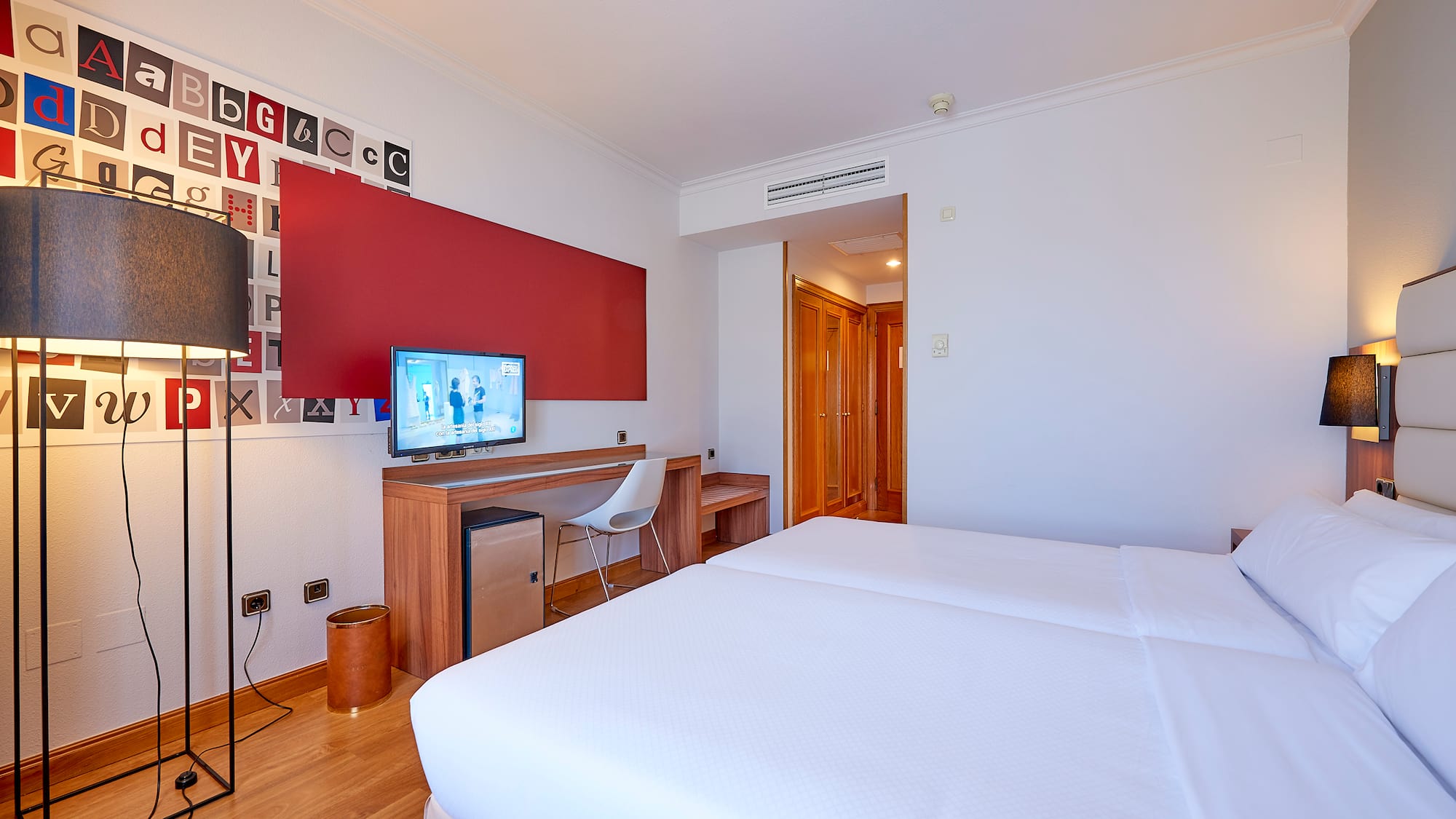 a room with a bed and a desk