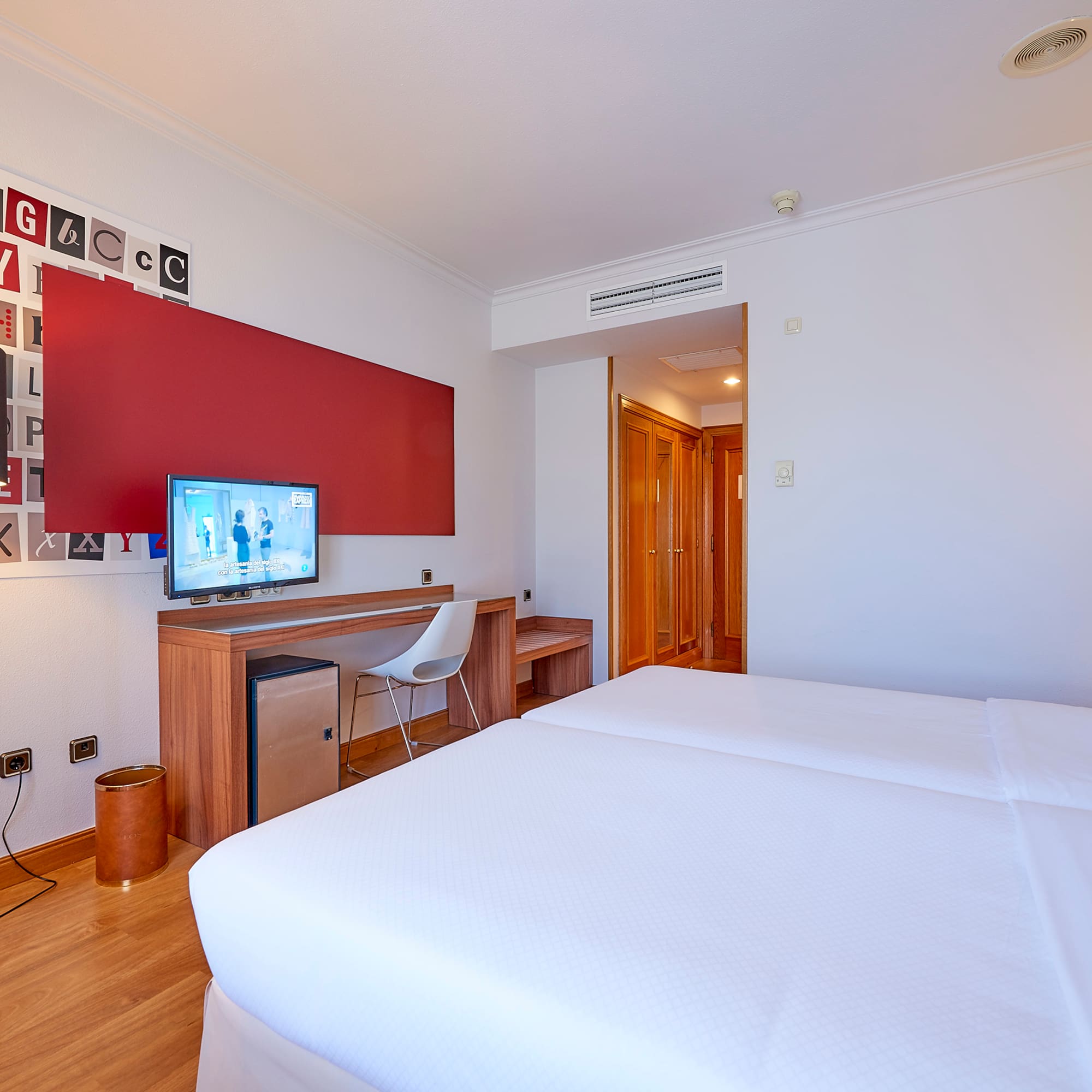 a room with a bed and a desk