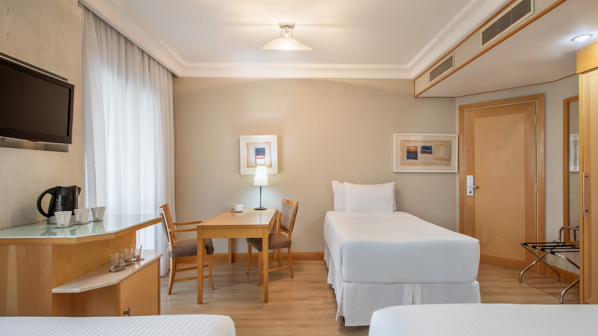 a room with two beds and a table