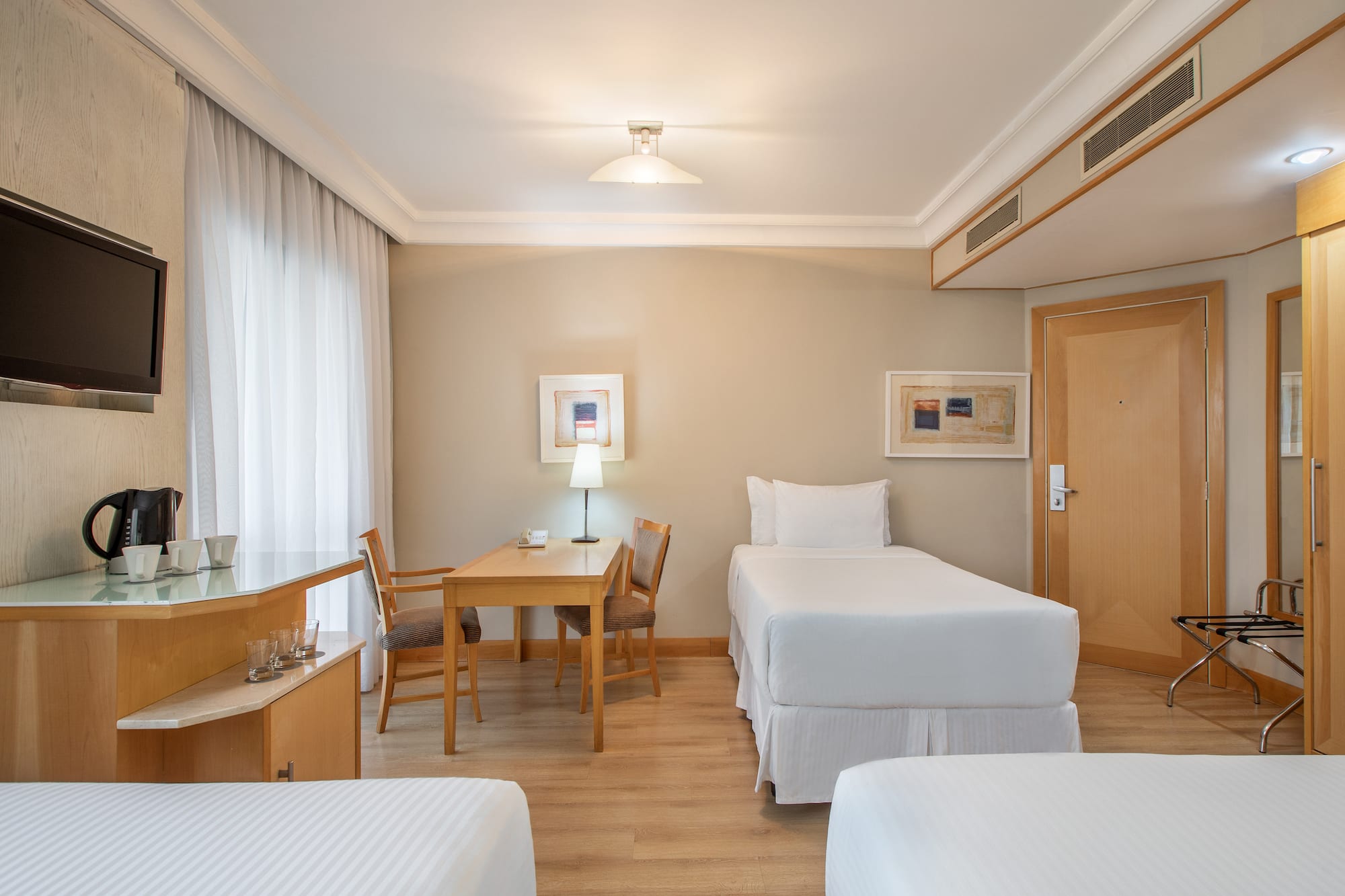 a room with two beds and a table