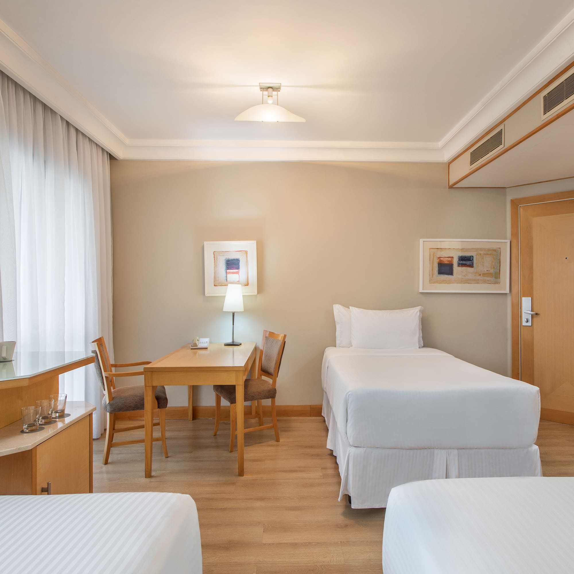 a room with two beds and a table