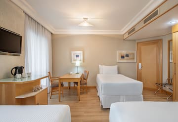 a room with two beds and a table