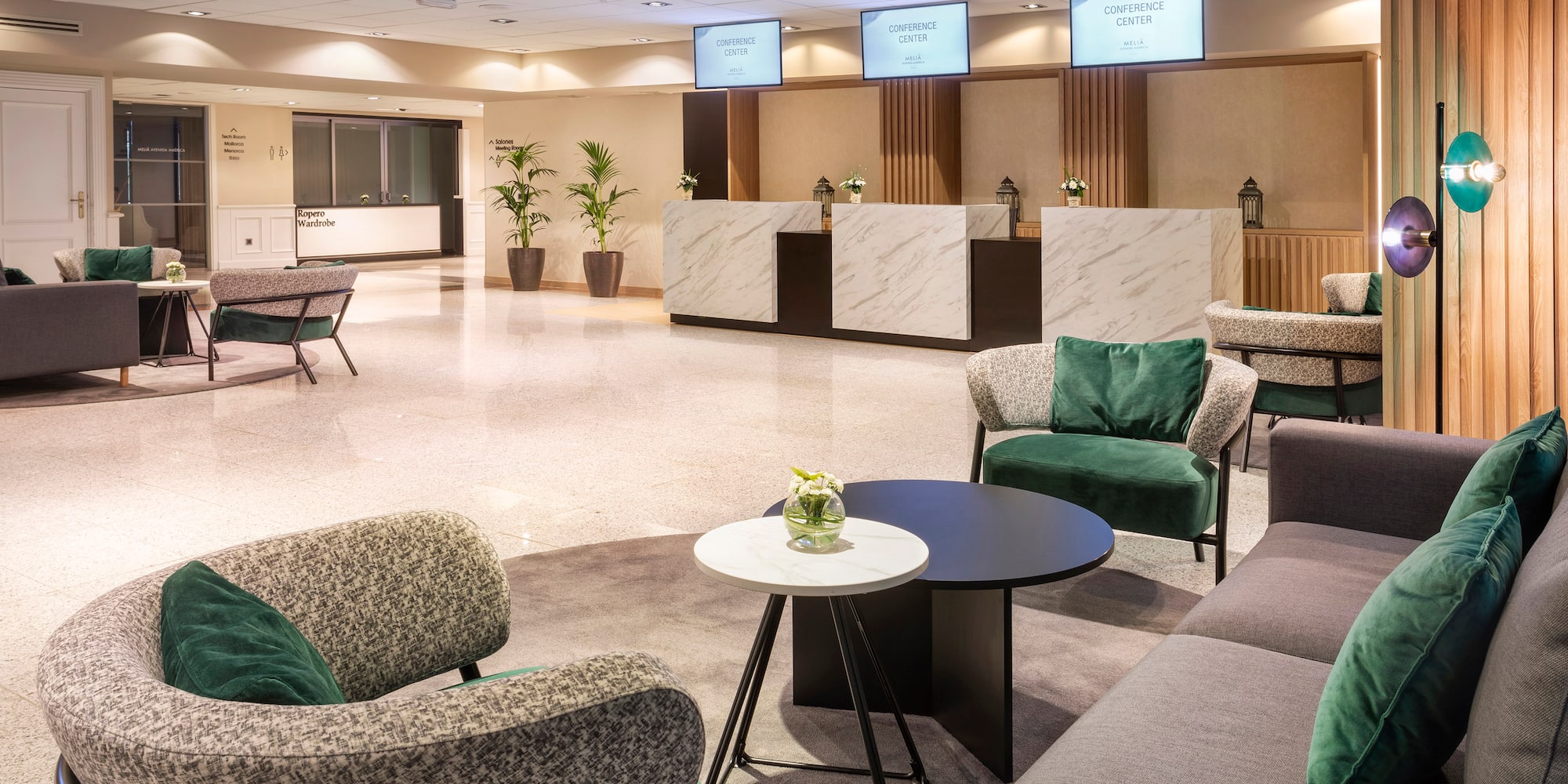 a room with a reception desk and chairs