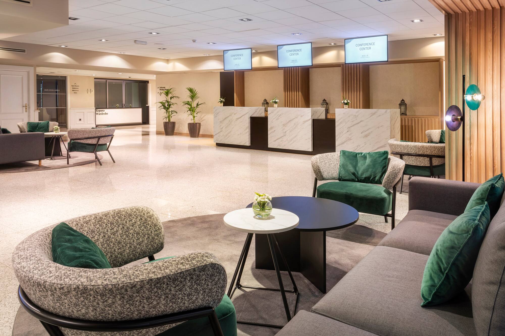 Hotel conference center lobby with modern lounge seating and reception.