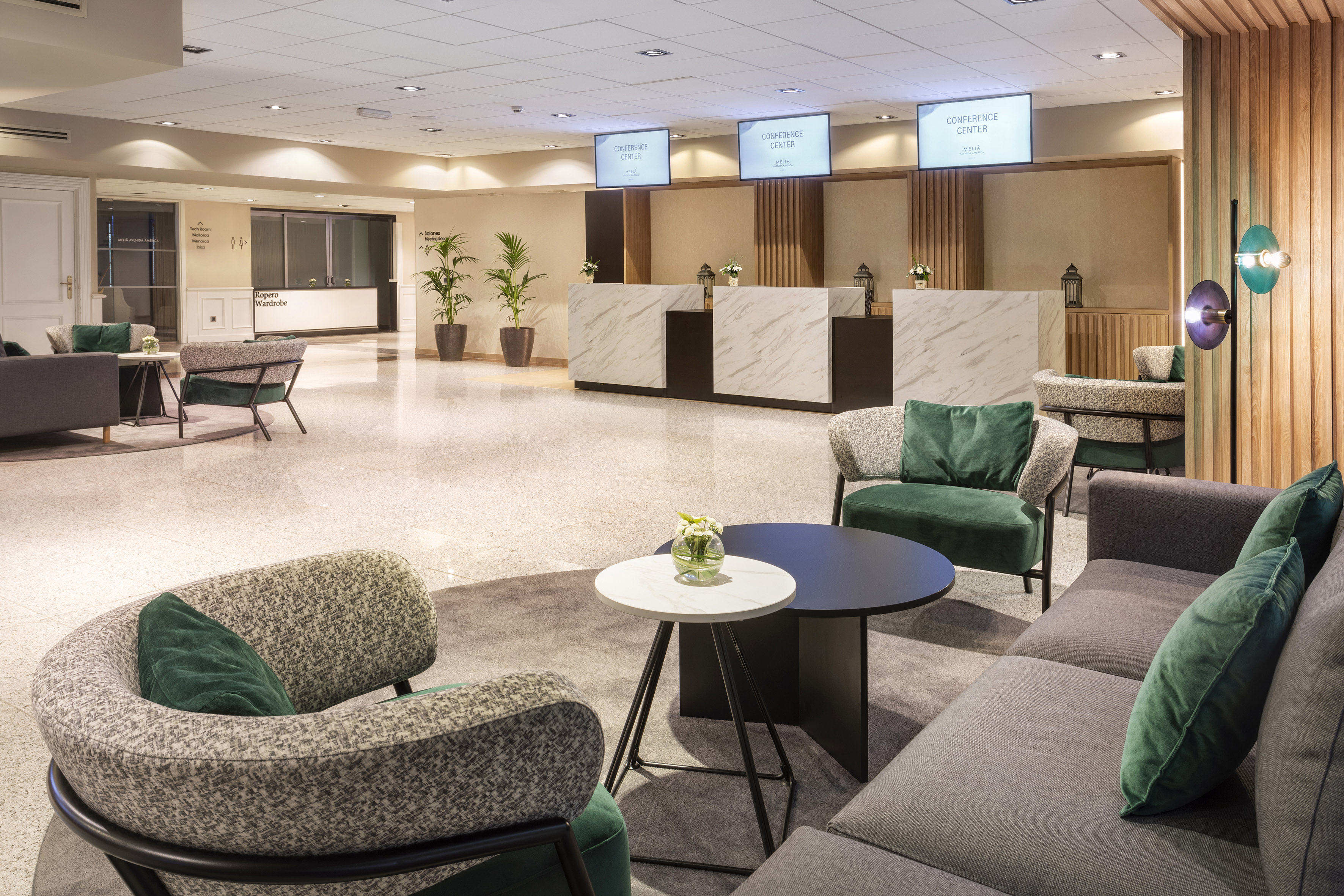 Hotel conference center lobby with modern lounge seating and reception.